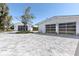Two pristine white garages with glass doors stand on a beautiful driveway at 45 Cape Haze Dr, Placida, FL 33946