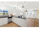 Bright kitchen featuring modern white cabinetry, black countertops, stainless appliances and tile backsplash at 45 Cape Haze Dr, Placida, FL 33946