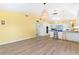 Bright kitchen featuring modern white cabinetry, breakfast bar, pendant lighting and laminate floors at 45 Cape Haze Dr, Placida, FL 33946