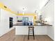 Bright kitchen with white cabinetry, black countertops, and stainless steel appliances, featuring modern fixtures at 45 Cape Haze Dr, Placida, FL 33946