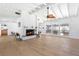 Bright living room featuring a fireplace, high ceilings with exposed beams, and expansive windows to the backyard at 45 Cape Haze Dr, Placida, FL 33946