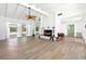 Bright living room featuring hardwood floors, a cozy fireplace, white vaulted ceilings, and an open floor plan at 45 Cape Haze Dr, Placida, FL 33946