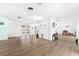 Spacious living room with white walls, light wood flooring, and sliding glass doors leading to the outdoors at 45 Cape Haze Dr, Placida, FL 33946