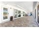 Spacious covered outdoor patio with tile flooring and multiple sliding glass doors at 45 Cape Haze Dr, Placida, FL 33946
