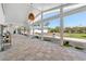 Spacious tiled patio enclosed with floor to ceiling windows offers natural light and backyard views at 45 Cape Haze Dr, Placida, FL 33946