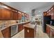 Spacious kitchen with stainless steel appliances, island cooktop, and breakfast bar seating at 4533 Friar Tuck Ln, Sarasota, FL 34232