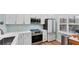 Bright, remodeled kitchen featuring modern appliances, white cabinetry, and a stainless steel sink at 4569 Morningside # 18, Sarasota, FL 34235
