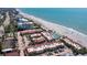 Breathtaking aerial view of beachside condos with pools and tennis courts, offering a luxurious coastal lifestyle at 4621 Gulf Of Mexico Dr # 19B, Longboat Key, FL 34228