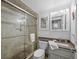 Bathroom featuring walk-in shower with glass door and neutral tile, complete with a granite vanity top at 4621 Gulf Of Mexico Dr # 19B, Longboat Key, FL 34228