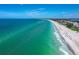 Scenic aerial view capturing the stunning coastline, calm ocean, and vibrant beachfront at 4621 Gulf Of Mexico Dr # 19B, Longboat Key, FL 34228