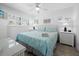 Cozy bedroom with a queen-size bed, coastal decor, and plenty of natural light from the window at 4621 Gulf Of Mexico Dr # 19B, Longboat Key, FL 34228