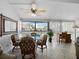Bright dining area features a glass table with seating for four and large windows with neighborhood views at 4621 Gulf Of Mexico Dr # 19B, Longboat Key, FL 34228