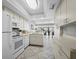 Bright kitchen with white appliances flows into the dining area, perfect for entertaining at 4621 Gulf Of Mexico Dr # 19B, Longboat Key, FL 34228
