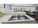 Kitchen sink with views to living room and windows at 4621 Gulf Of Mexico Dr # 19B, Longboat Key, FL 34228