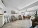 Open living space with tile flooring, ceiling fan, and dining area next to bright windows at 4621 Gulf Of Mexico Dr # 19B, Longboat Key, FL 34228