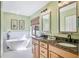 Luxurious bathroom with a soaking tub, double vanity, and elegant finishes at 4770 Maid Marian Ln, Sarasota, FL 34232