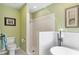 Bathroom with tile shower, freestanding tub, and neutral walls at 4770 Maid Marian Ln, Sarasota, FL 34232