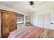 Bedroom with neutral walls, wood floors, and closet space at 4770 Maid Marian Ln, Sarasota, FL 34232