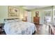 Bedroom with wooden floors, ensuite bathroom with freestanding tub at 4770 Maid Marian Ln, Sarasota, FL 34232