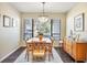 Cozy dining room with hardwood floors and natural light at 4770 Maid Marian Ln, Sarasota, FL 34232