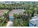 Beautiful home with lush tropical landscaping, tile roof, and screened-in lanai with views of the water at 5007 Palermo Dr, Punta Gorda, FL 33950