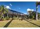 Expansive backyard with a screened-in lanai and lush tropical landscaping, perfect for outdoor living and entertaining at 5007 Palermo Dr, Punta Gorda, FL 33950