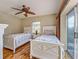Bright bedroom with two twin beds, nautical bedding, a ceiling fan and direct access to the patio at 5007 Palermo Dr, Punta Gorda, FL 33950
