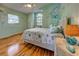 Charming bedroom with laminate wood flooring, sea-themed decorations and wall art, with natural light at 5007 Palermo Dr, Punta Gorda, FL 33950