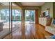 Bedroom with wood floors, ceiling fan, sliding glass doors to the pool area at 5007 Palermo Dr, Punta Gorda, FL 33950