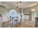 Bright dining room featuring a chandelier and large window with shutters, creating an inviting atmosphere at 5007 Palermo Dr, Punta Gorda, FL 33950