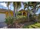 Yellow house with an arched doorway and several palm trees at 5007 Palermo Dr, Punta Gorda, FL 33950