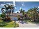 Beautiful single-story home featuring a tile roof, two-car garage and lush landscaping including palm trees at 5007 Palermo Dr, Punta Gorda, FL 33950