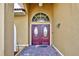 Elegant double front doors with decorative glass accents and arched transom window creating a welcoming entrance at 5007 Palermo Dr, Punta Gorda, FL 33950