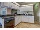 Well-lit kitchen with white cabinetry, granite countertops, stainless steel appliances, and an open layout at 5007 Palermo Dr, Punta Gorda, FL 33950