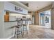 Eat-in kitchen featuring granite counters, white cabinets, breakfast bar and tile floors at 5007 Palermo Dr, Punta Gorda, FL 33950