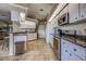 Kitchen featuring stainless steel appliances, granite counters, white cabinets and tile floors at 5007 Palermo Dr, Punta Gorda, FL 33950