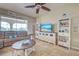 Cozy living room featuring tile flooring, ceiling fan, and coastal decor with view of backyard at 5007 Palermo Dr, Punta Gorda, FL 33950