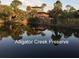 Scenic view of Alligator Creek Preserve, showcasing a wooden structure reflected in the calm water at 5007 Palermo Dr, Punta Gorda, FL 33950