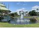 Scenic view of Laishley Park featuring a gazebo, pond, fountain, and palm trees at 5007 Palermo Dr, Punta Gorda, FL 33950