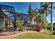 Screened in patio with lush landscaping and green lawn at 5007 Palermo Dr, Punta Gorda, FL 33950