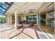 Outdoor patio featuring brick pavers, a grill, ceiling fans, and comfortable wicker seating at 5007 Palermo Dr, Punta Gorda, FL 33950