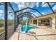 A stunning view of a screened-in pool with brick patio and landscaping at 5007 Palermo Dr, Punta Gorda, FL 33950