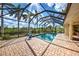 Screened in pool area with brick pavers and tropical landscaping at 5007 Palermo Dr, Punta Gorda, FL 33950
