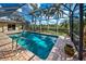 Screened-in pool with brick patio and stainless steel handrail entry at 5007 Palermo Dr, Punta Gorda, FL 33950