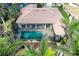 Screened-in pool of waterfront property surrounded by tropical landscaping at 5007 Palermo Dr, Punta Gorda, FL 33950