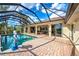Large screened-in pool with brick paver deck and backyard landscaping at 5007 Palermo Dr, Punta Gorda, FL 33950