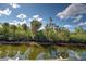 Scenic view of a tranquil waterway with lush vegetation reflecting in the calm water at 5007 Palermo Dr, Punta Gorda, FL 33950
