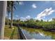 Picturesque view of waterway, lush greenery, a privacy fence, with water reflections at 5007 Palermo Dr, Punta Gorda, FL 33950
