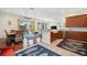 Open kitchen with wood cabinets, stainless appliances, a granite counter, and a view into the dining room at 5112 52Nd W Ave, Bradenton, FL 34210