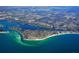 Expansive aerial view of a coastal city featuring vibrant waterways, pristine beaches, and a dense urban landscape by the ocean at 5169 Sandy Shore Ave, Sarasota, FL 34242